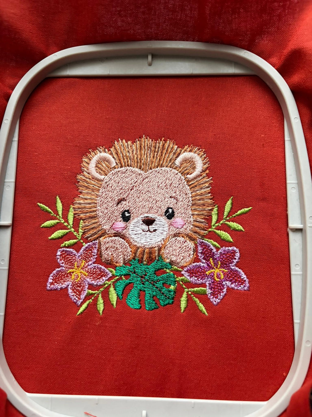 Motif de broderie machine Lionceau Fleuri entouré de fleurs tropicales et feuillages, disponible en 3 tailles
